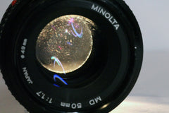 Minolta MD 50mm f1.7 lens with light shining through from behind showing haze and dust inside