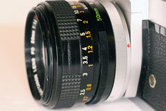 Side of the B&H/Canon 50mm f1.4 lens showing missing part of rubber grip on focusing ring